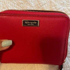 Red Kate Spade wallet. Tons of pockets. Good condition